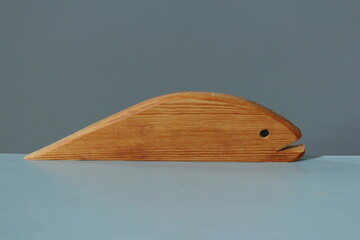 A wooden fish figurine close-up, with a distinct wood texture