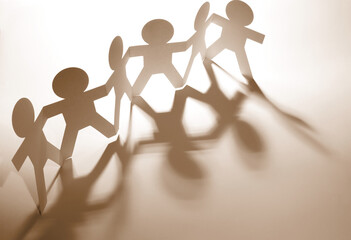 Paper chain team holding hands united