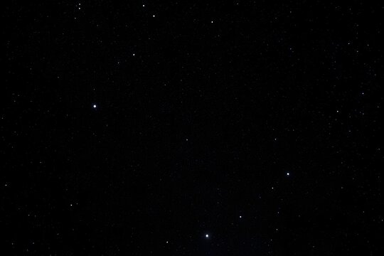 A black sky with a few stars in it