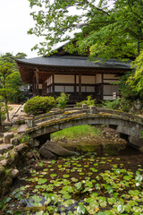 Fototapeta premium Zenno-ji Temple and stone bridge surrounded by greenery in Takayama