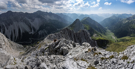 Mountaineer climbing challenging rocky ridge on the Maldongrat in Tyrol Alps, dynamic action shot with rugged terrain and alpine environment. © ikoon