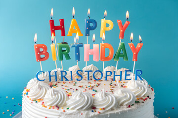 Colorful "happy birthday" candles and "christopher" name on white cake, isolated on transparent background