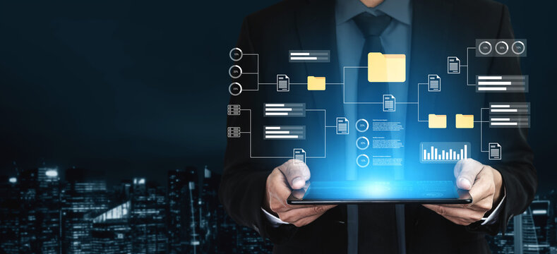 A business professional holds a tablet showcasing a digital interface filled with data and analytics, set against a modern city skyline at night, symbolizing innovation. Gantry - Powered by Adobe