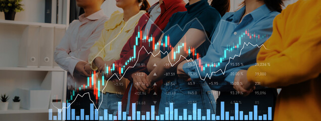 A diverse group of professionals stands together in a modern office, analyzing financial data and...