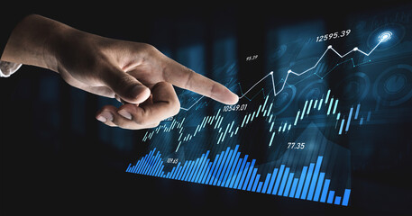 A close-up of a human hand pointing towards a dynamic financial graph showcasing upward trends and data visualizations, ideal for investment and analysis themes. Scalp