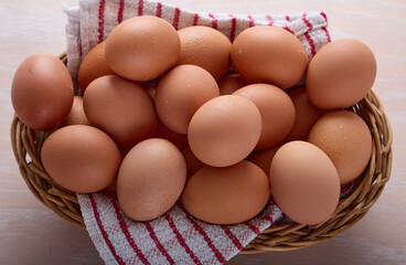 Fresh Brown Chicken Eggs in Wicker Basket