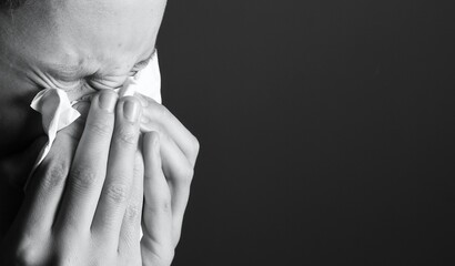 flu epidemic with child blowing nose after catching a cold with people on grey background stock...
