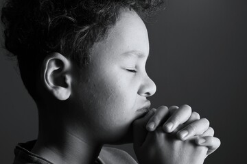 little boy praying to God with hands together with people stock image stock photo 