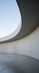 Fototapeta premium Curved concrete wall and floor showcase minimalist architecture, creating a sense of space and serenity, ideal for design or architectural concepts
