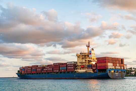 Miami, Florida, USA - November 25, 2024: Freight container on cargo vessel. Cargo ship vessel. Container ship. Cargo Annie B Monrovia ship services with container leaving port, drone view