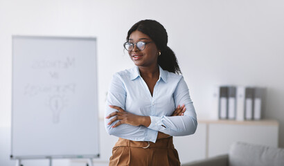 Psychological education. Successful black business coach giving personal growth training, posing...
