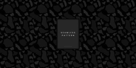 Modern seamless pattern featuring large abstract organic shapes resembling camouflage or stone fragments in dark monochrome grey on a black background © gegen