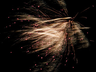 Coordinated display of luminous explosions crafts elegant canopy above amusement park