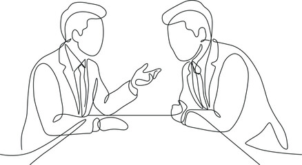 Two men discussing business at a table
