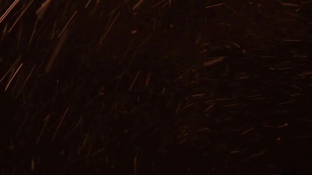 Violent snowstorm at night with snowflakes blowing aggressively through the air. Snow fall isolated on black background. Powerful winter weather scene ideal for blizzard concepts and extreme cold.
