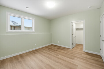 Fototapeta premium Very clean and empty room with a white wall and wooden floors