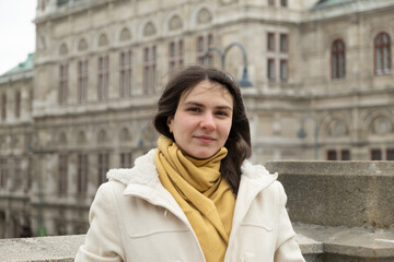 Fototapeta premium Close up portrait of a young thirty-year-old European woman in white coat in winter.