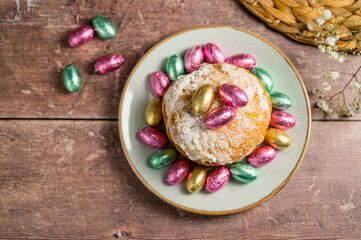  Easter spring holiday background. Cake with chocolate easter eggs, gypsophila flowers