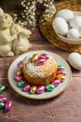  Easter spring holiday background. Cake with chocolate easter eggs, gypsophila flowers and bunny