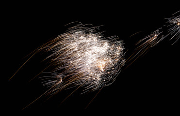 Silver sparks soar, Bright silver fireworks gently drift across night sky
