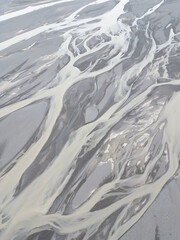 Fototapeta premium Aerial shot of the river streams from Icelandic glaciers