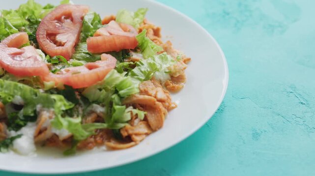 Close-Up of Chicken Kapsalon with Turkish Doner on White Plate