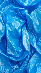 Obraz premium Close-up of crumpled, translucent, brilliant blue material. The light reflects off the folds, creating a dynamic texture