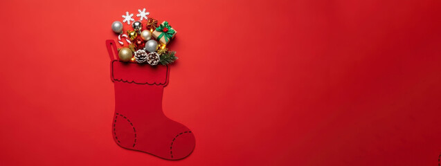 Christmas Stocking Illustration with 3D Festive Decorations, Flat Lay Holiday Concept on Red Background with Ornaments, Gifts, and Candy Cane