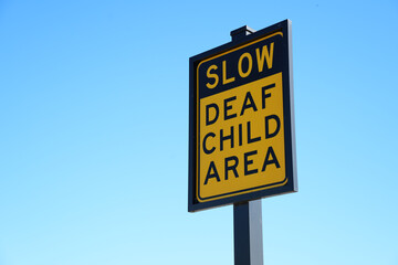Warning Sign on Residential Street Urging Caution because of a Deaf Child Living Nearby