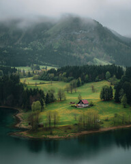 AI generator images of landscape of this valley comprises stunning Himalayan peaks, lakes, and pastures. Lush meadows, snow-covered wild plum trees, and beautiful hiking trails.