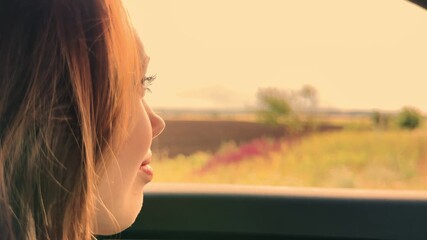 Radiant face of a girl in the car, Woman savoring freedom while traveling, Peaceful smile by the window, Girl appreciating travel moments, Human spirit lifted by new places, Pure happiness on a road