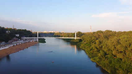Fototapeta premium Aerial view of a pedestrian bridge over the Ural River in Orenburg