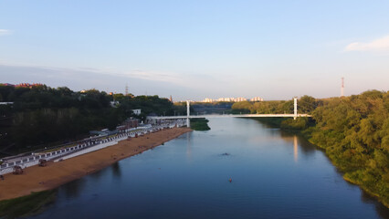 Fototapeta premium Aerial view of a pedestrian bridge over the Ural River in Orenburg