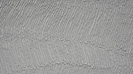 A close-up view of a textured gray fabric with a rough, woven pattern