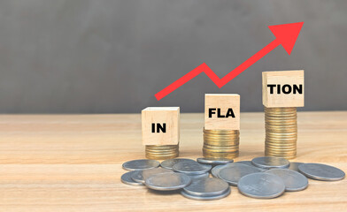 inflation word on wooden cube coins in idea for FED consider interest rate hike, world economics, and inflation control, US dollar inflation, price hike increase