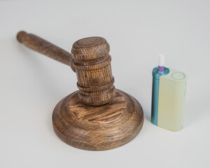 Judge's gavel and electronic cigarette. Smoking ban. Tobacco heating systems. 