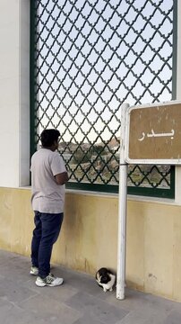 Signage for Maqbarat Shuhada Badr, marking the historic cemetery of the martyrs of Badr in Medina, a solemn site linked to early Islamic battles, remembrance, and pilgrimage heritage.
