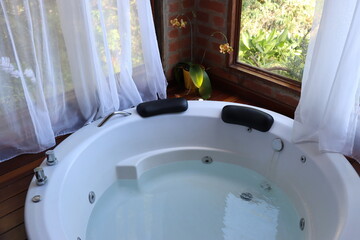Whirlpool bath in a romantic space surround by a wood deck and nature view