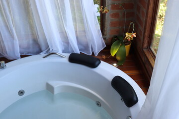 Whirlpool bath in a romantic space surround by a wood deck and nature view
