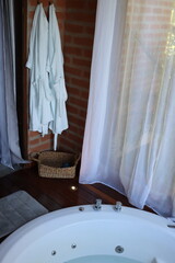 Whirlpool bath in a romantic space surround by a wood deck and nature view
