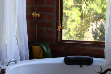 Whirlpool bath in a romantic space surround by a wood deck and nature view