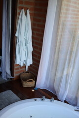 Whirlpool bath in a romantic space surround by a wood deck and nature view
