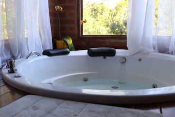 Whirlpool bath in a romantic space surround by a wood deck and nature view