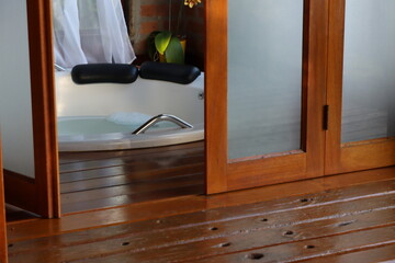 Whirlpool bath in a romantic space surround by a wood deck and nature view