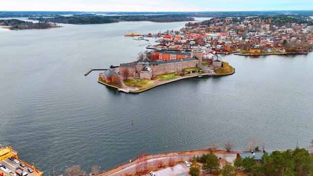 Flying over Lake Malar approaching the stunning 16 century Vaxholm Fortress, Sweden. City scenery at backdrop.