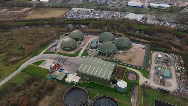 Aerial drone view of sewage plant industrial buildings, domed tanks and infrastructure for clean drinking water and sanitation in Derby, United Kingdom. 