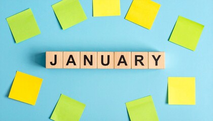 January Word Made From Wooden Letter Cubes Surrounded by Blank Sticky Notes
