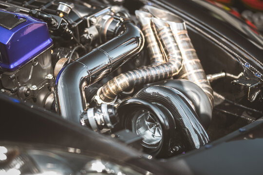 Close-up of a high-performance car engine with turbocharger and exhaust system