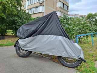 Cover on a motorcycle parked near the house © Harmony Video Pro