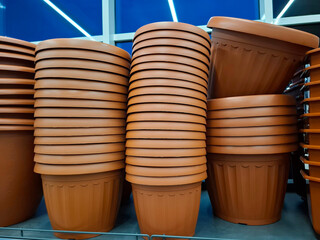 Plastic flower pots are sold at flower shop. Large flower pots in a store